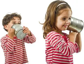 two kids talking on a tin phone
